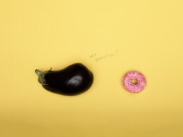 pink doughnut on yellow surface