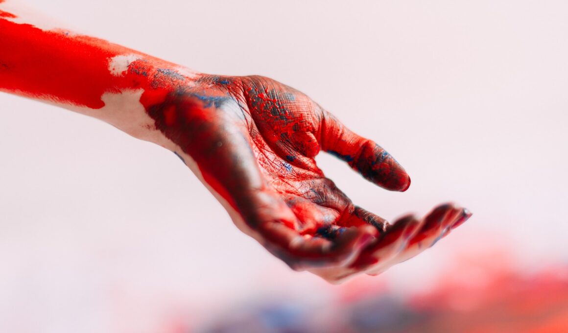 a person's hand with red and white paint on it
