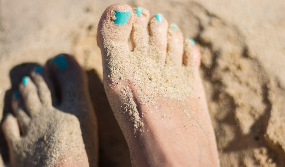 person sky-blue nail polish feet on brown sand